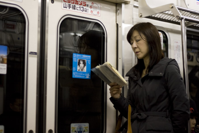 Gente leyendo en el metro de Tokyo